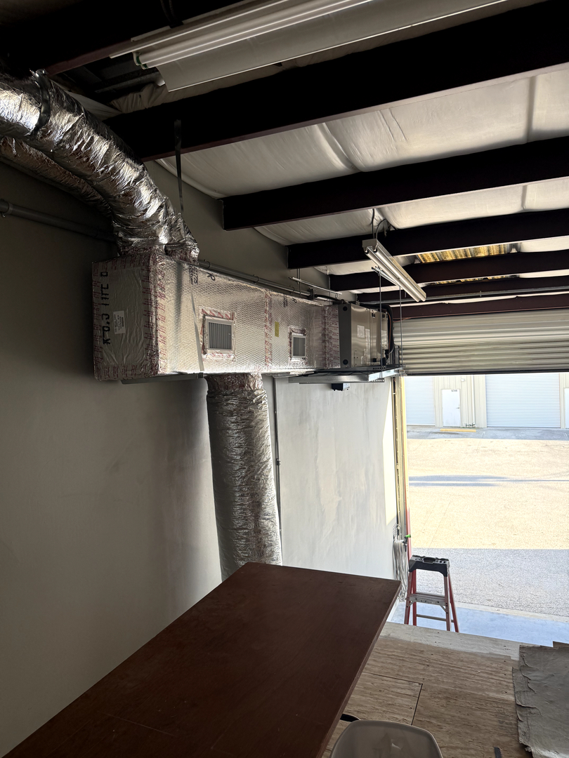 Professional HVAC technician repairing air conditioning unit